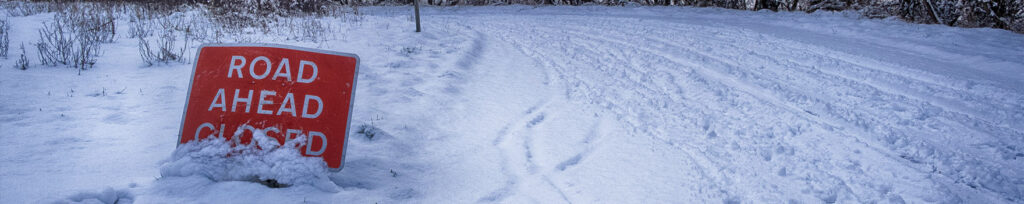 Road closed sign in snow